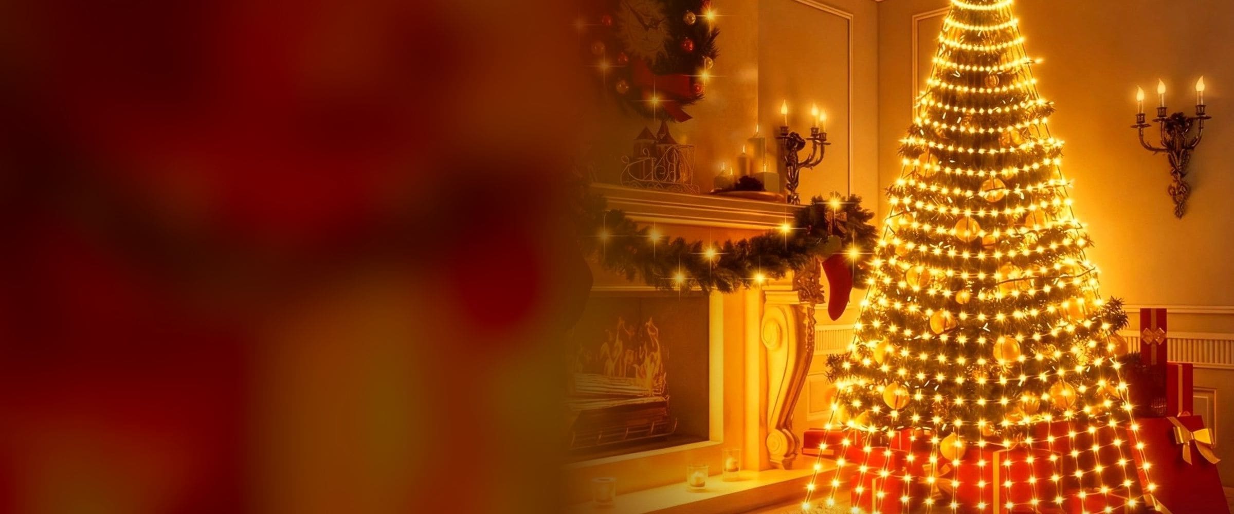 Christmas tree wrapped in warm waterfall lights beside a fireplace